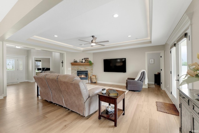 201 Thoroughbred Ln, Auburn, IN 46706 - living room with a tray ceiling, a ceiling fan, light wood finished floors, a stone fireplace, and recessed lighting