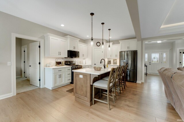 201 Thoroughbred Ln, Auburn, IN 46706 - kitchen featuring stainless steel appliances, a kitchen bar, light wood finished floors, and recessed lighting