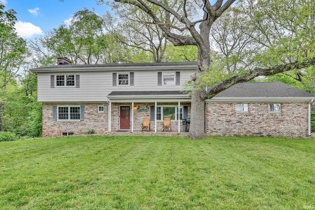 3422 W 200 S, Lafayette, IN 47909 - view of front facade featuring brick siding, a front yard, and a chimney