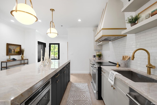 622 N Notre Dame Ave, South Bend, IN 46617 - kitchen featuring stainless steel appliances, custom exhaust hood, a sink, light wood finished floors, and decorative backsplash