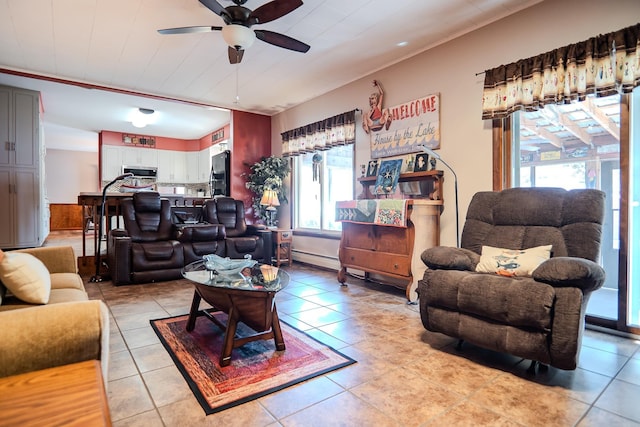 315 E Effie Mae St, North Webster, IN 46555 - living room featuring a ceiling fan, light tile patterned flooring, and baseboard heating