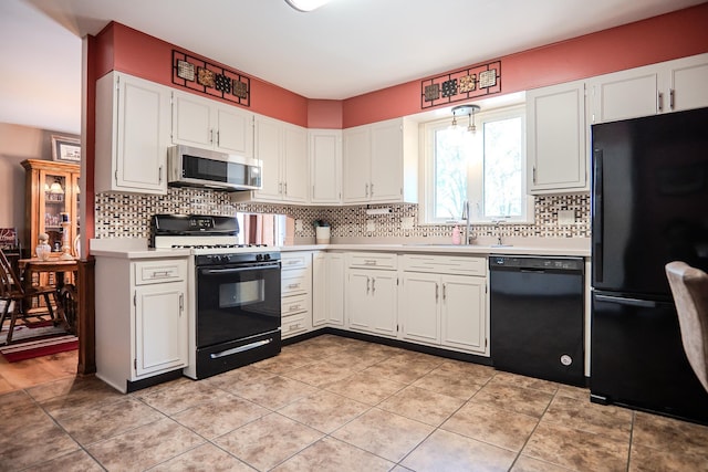 315 E Effie Mae St, North Webster, IN 46555 - kitchen with black appliances, light countertops, a sink, backsplash, and white cabinets