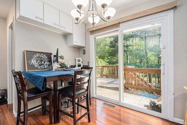 dining space with a chandelier and light wood-style flooring
