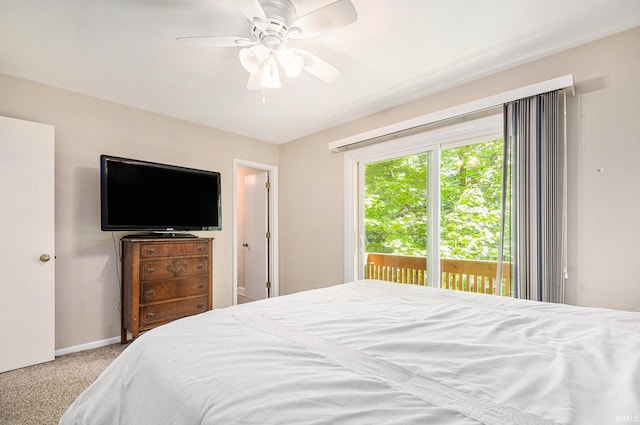 carpeted bedroom with access to outside, a ceiling fan, and baseboards
