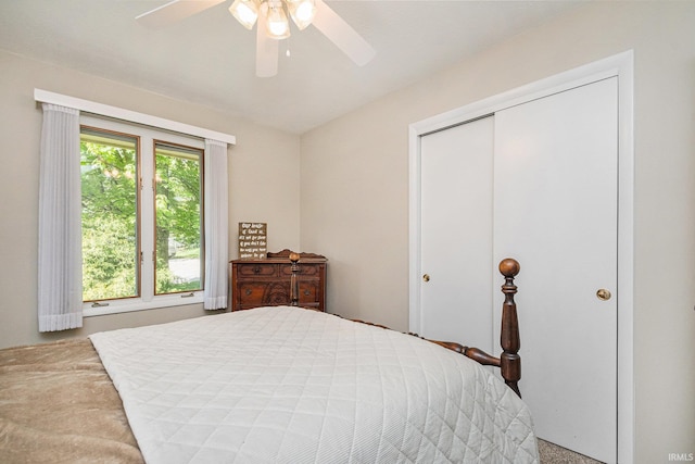 carpeted bedroom featuring a closet and a ceiling fan