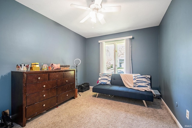 living area with carpet, ceiling fan, and baseboards
