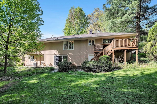 rear view of property featuring a deck, stairway, a yard, and a chimney