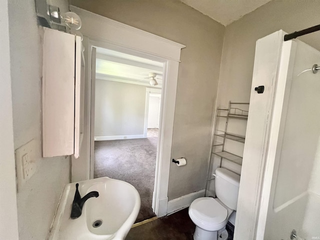bathroom with toilet and baseboards