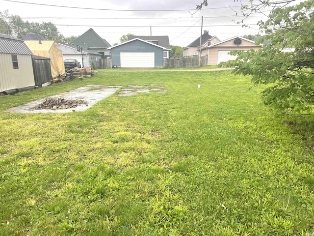 view of yard featuring an outbuilding and a garage