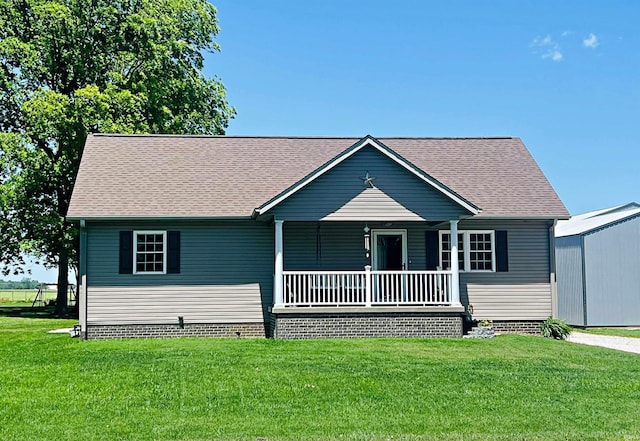 12820 E 150 N, Loogootee, IN 47553 - view of front of house with covered porch, a front yard, and a shingled roof