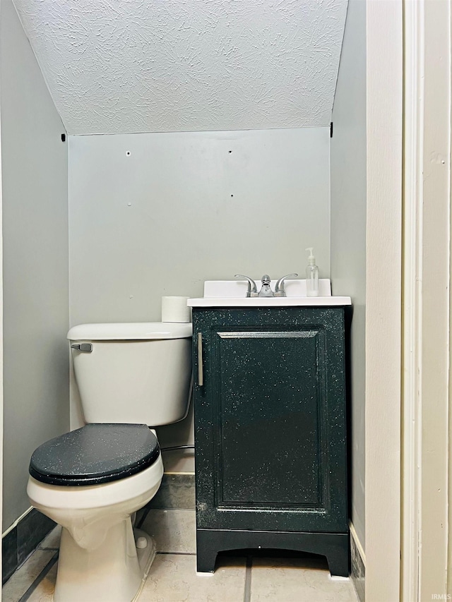 12820 E 150 N, Loogootee, IN 47553 - bathroom with vanity, toilet, a textured ceiling, and baseboards
