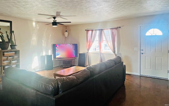 12820 E 150 N, Loogootee, IN 47553 - living room featuring a textured ceiling, ceiling fan, and baseboards
