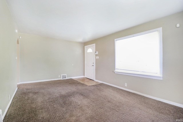 1714 S Warren St, South Bend, IN 46613 - unfurnished living room featuring carpet flooring and baseboards