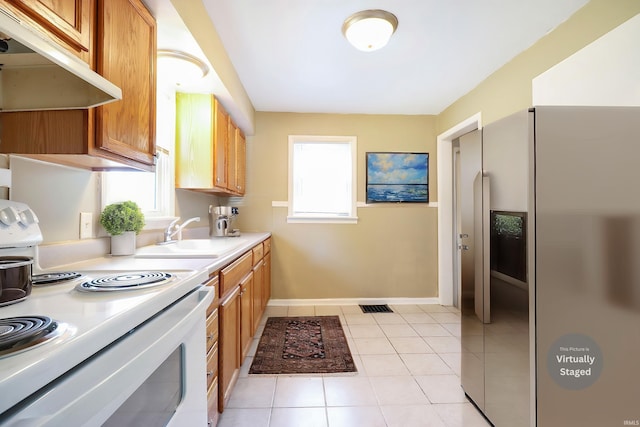 1714 S Warren St, South Bend, IN 46613 - kitchen with electric range, stainless steel fridge with ice dispenser, under cabinet range hood, a sink, and light countertops
