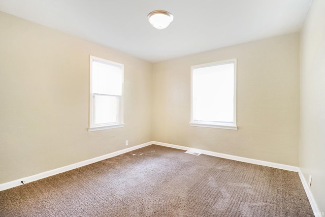 1714 S Warren St, South Bend, IN 46613 - unfurnished room with plenty of natural light, carpet flooring, and baseboards
