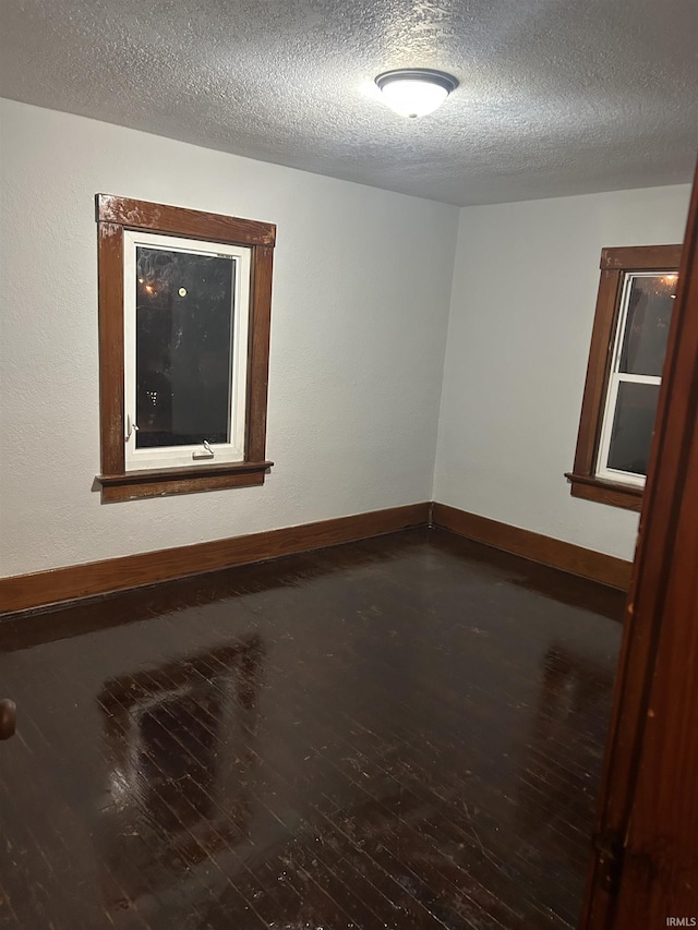 2931 Alexander St, Fort Wayne, IN 46806 - spare room featuring wood finished floors, baseboards, and a textured ceiling