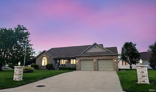 single story home featuring concrete driveway, a garage, a yard, a porch, and brick siding