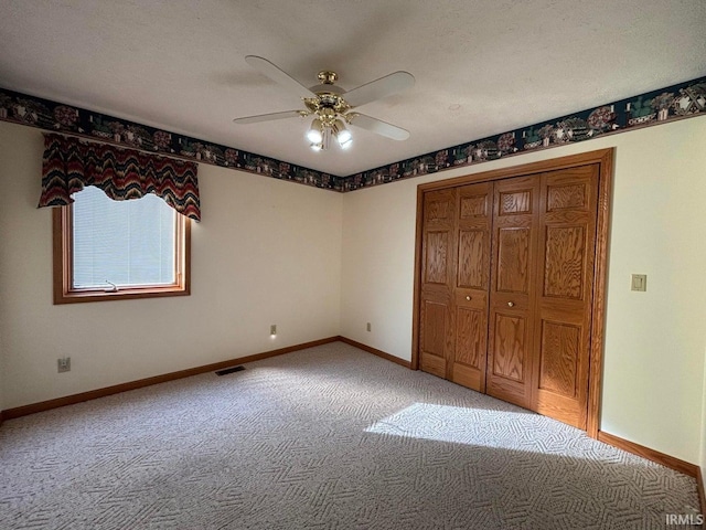 unfurnished bedroom featuring light carpet, baseboards, and ceiling fan