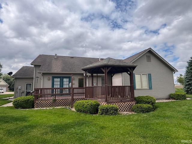 back of house with a deck, a yard, a shingled roof, and a gazebo