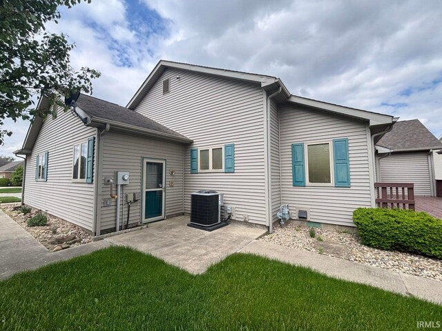 rear view of house featuring cooling unit and a patio area