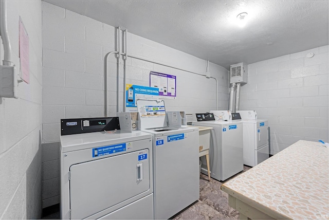 2937 Westbrook Dr Unit A-314, Fort Wayne, IN 46805 - community laundry room with washing machine and dryer, concrete block wall, and a textured ceiling