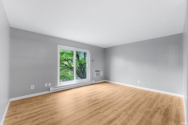 2937 Westbrook Dr Unit A-314, Fort Wayne, IN 46805 - unfurnished room with a baseboard heating unit, baseboards, wood finished floors, and an AC wall unit