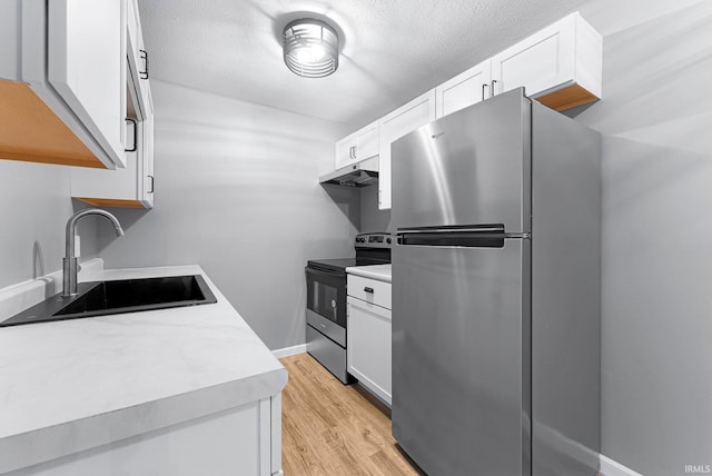 2937 Westbrook Dr Unit A-314, Fort Wayne, IN 46805 - kitchen featuring stainless steel appliances, a sink, under cabinet range hood, light countertops, and a textured ceiling