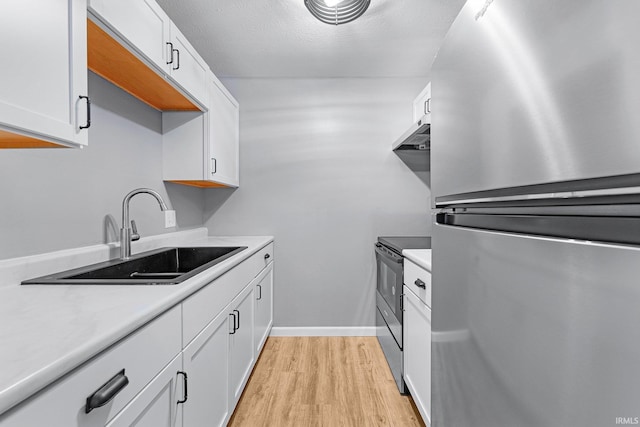 2937 Westbrook Dr Unit A-314, Fort Wayne, IN 46805 - kitchen with freestanding refrigerator, a sink, electric stove, light wood finished floors, and light countertops