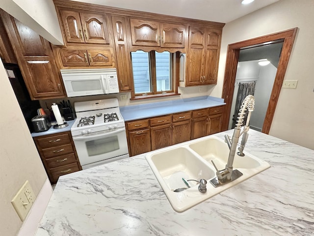 1655 Hinton Dr, Fort Wayne, IN 46808 - kitchen with white appliances, light countertops, a sink, and brown cabinetry