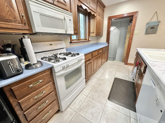 1655 Hinton Dr, Fort Wayne, IN 46808 - kitchen featuring white appliances, a sink, light countertops, and light tile patterned flooring