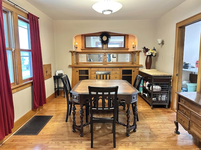 1655 Hinton Dr, Fort Wayne, IN 46808 - dining area with light wood-style floors, arched walkways, and baseboards