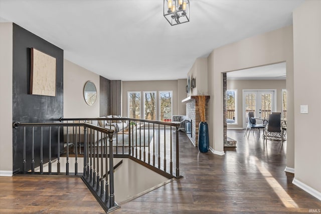 2344 E Linden Hill Dr, Bloomington, IN 47401 - stairs featuring wood finished floors, a brick fireplace, baseboards, and french doors