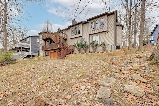 2344 E Linden Hill Dr, Bloomington, IN 47401 - back of house with stairs, a chimney, and a deck