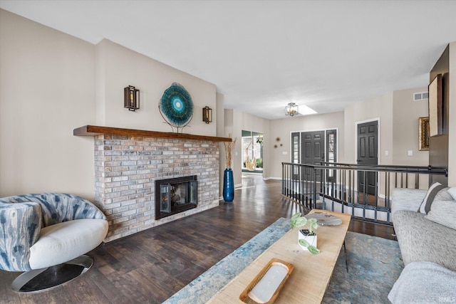 2344 E Linden Hill Dr, Bloomington, IN 47401 - living room featuring wood finished floors, a brick fireplace, and baseboards