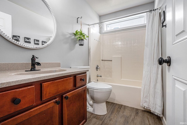 full bath with wood finished floors, vanity, shower / bath combo, and toilet