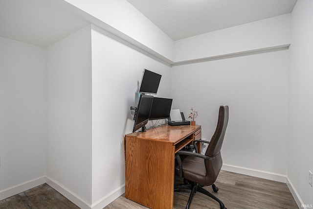 office space featuring wood finished floors and baseboards