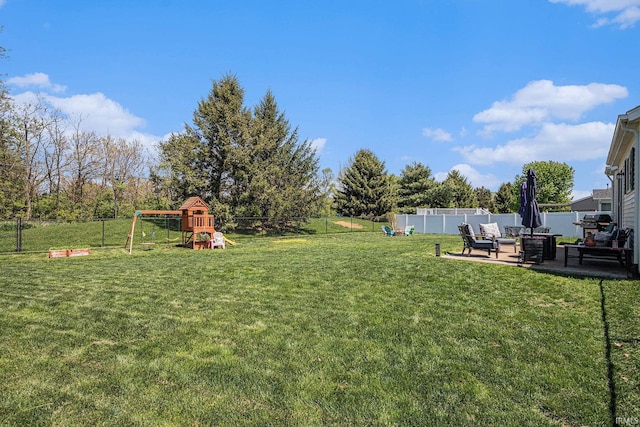 view of yard featuring a playground, a patio area, and an outdoor living space