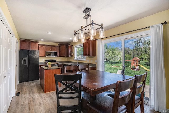 dining area with light wood-style flooring and recessed lighting