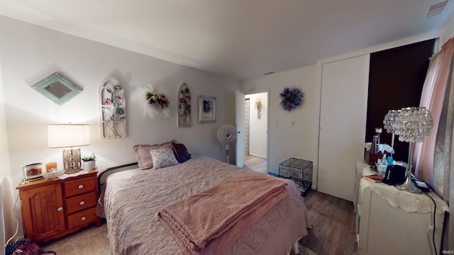 bedroom featuring light wood-type flooring and a closet