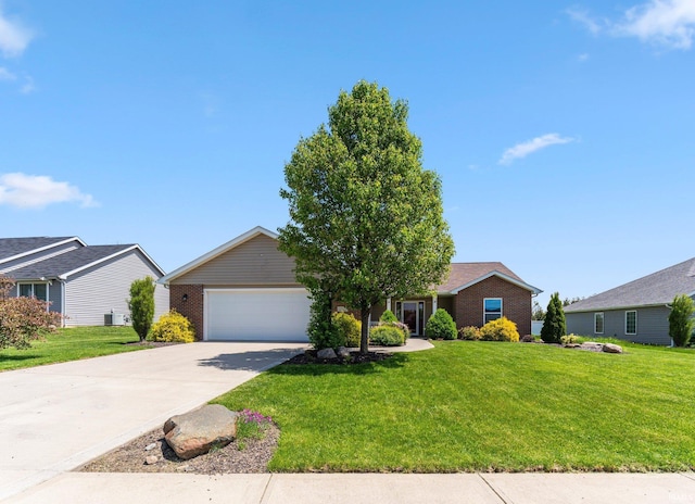 view of front facade with a garage, driveway, a front yard, and brick siding