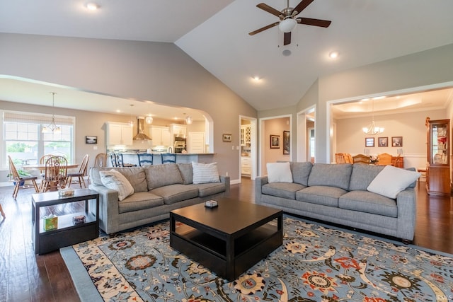 living area featuring a chandelier, dark wood finished floors, ceiling fan, recessed lighting, and arched walkways