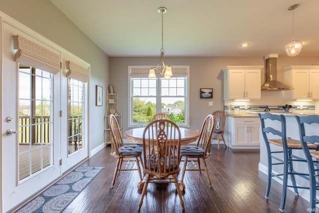 dining space featuring baseboards, dark wood-type flooring, recessed lighting, and a chandelier