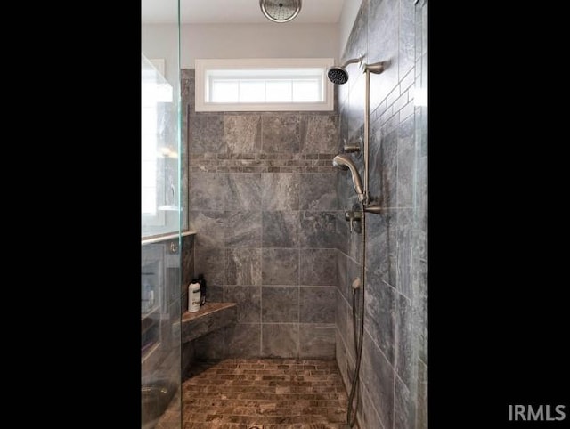 full bathroom with tiled shower