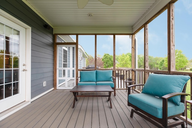 sunroom / solarium featuring healthy amount of natural light, ceiling fan, and outdoor lounge area