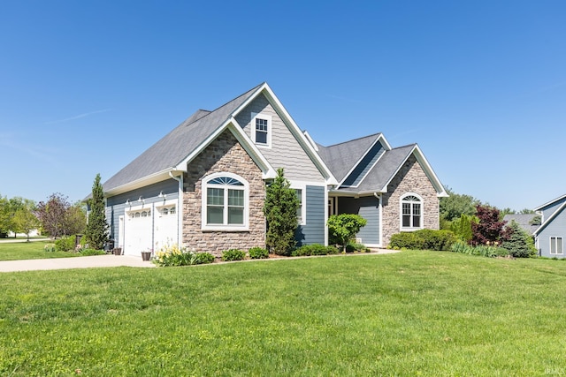 craftsman inspired home featuring stone siding, a front yard, and driveway