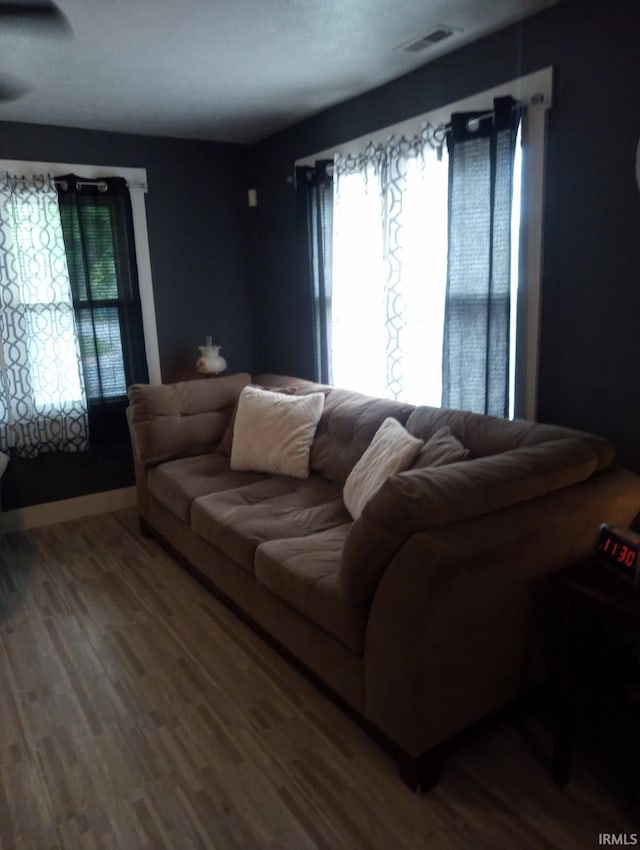 living area featuring healthy amount of natural light and wood finished floors