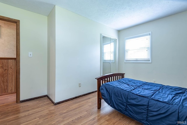 3721 W Maybury Mall, Bloomington, IN 47403 - bedroom with light wood-type flooring, baseboards, a textured ceiling, and a closet