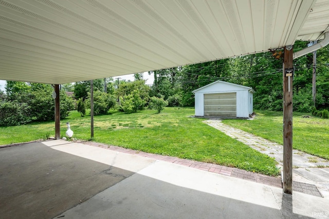 3721 W Maybury Mall, Bloomington, IN 47403 - view of grassy yard with a patio area, an outbuilding, driveway, and view of wooded area