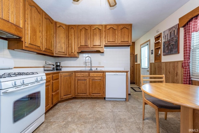3721 W Maybury Mall, Bloomington, IN 47403 - kitchen featuring white appliances, a sink, brown cabinets, tasteful backsplash, and a wainscoted wall