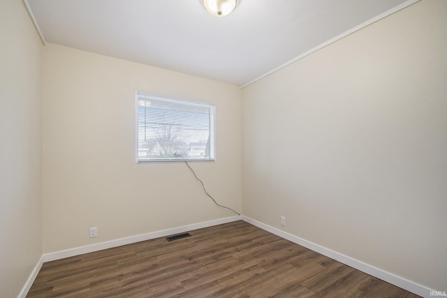 unfurnished room with dark wood-style floors and baseboards